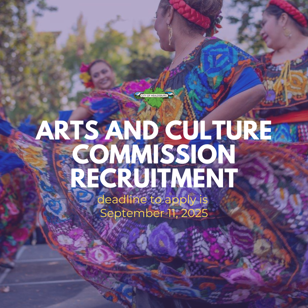 Two women wearing colorful dresses dancing